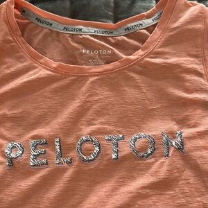 Pretty peach Peloton tank with gray lettering